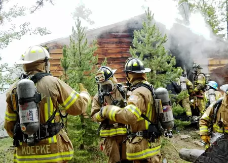 Firefighters outside a cabin
